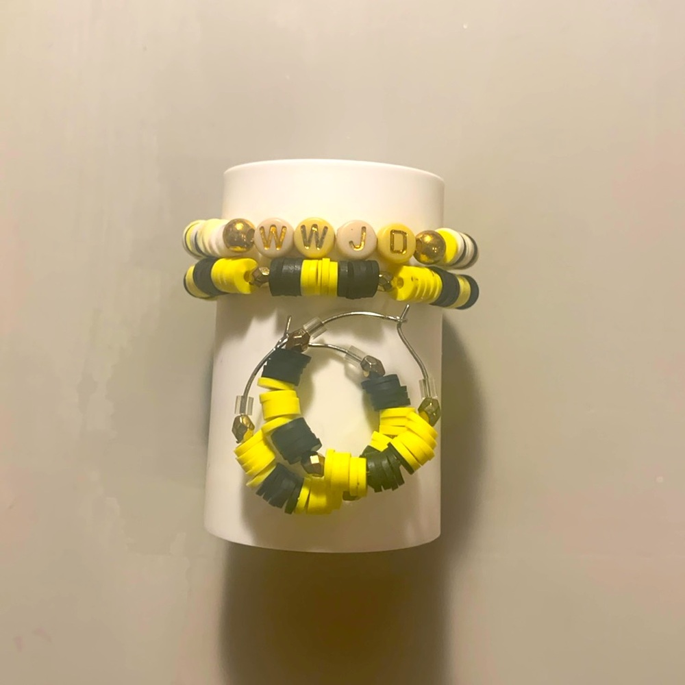 One pair of hoop earrings, and two matching yellow and black bracelets.